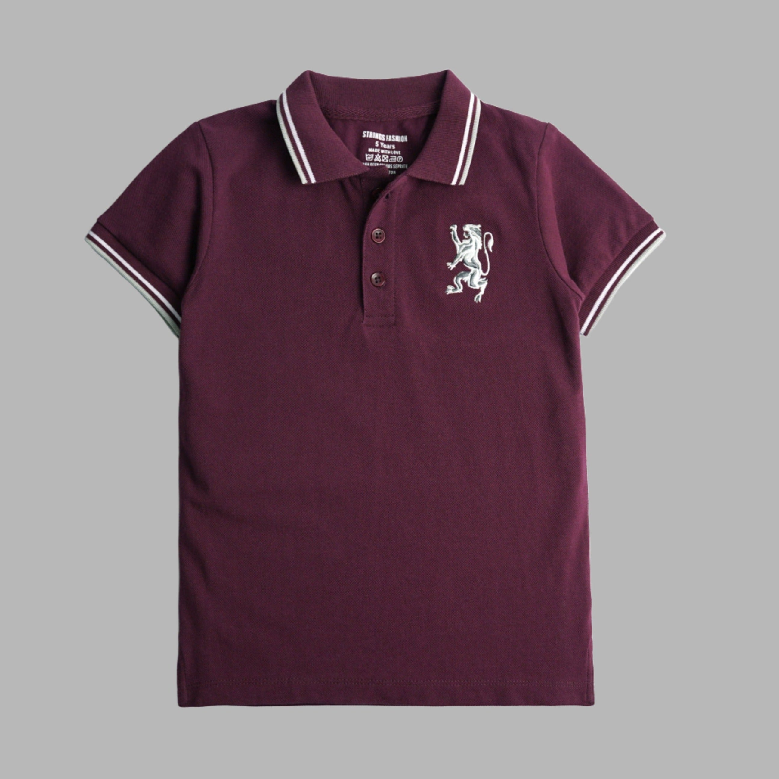 A burgundy short sleeve polo t-shirt for boys with a white collar and a white embroidered emblem on the chest.