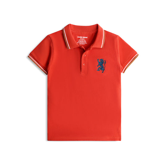 A red short-sleeved boys' polo t-shirt with a blue emblem on the chest, white collar, and white trim on the sleeves. 2000