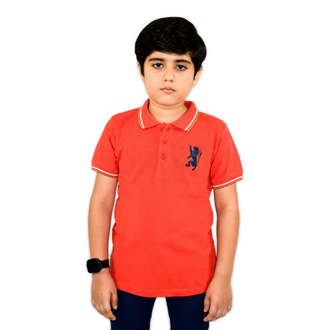A red short-sleeved boys' polo t-shirt with a blue emblem on the chest, white collar, and white trim on the sleeves.